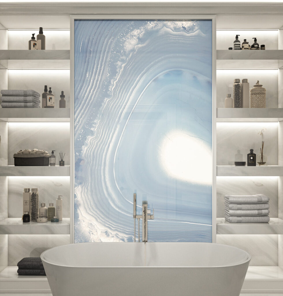 A bright modern bathroom with bathtub, shelving, and a large, backlit artwork of a blue geode