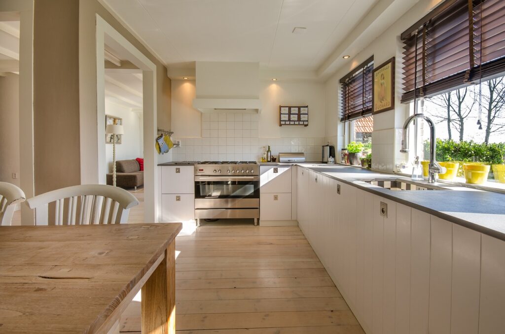 A brightly lit kitchen with plenty of floor space between furniture and cabinets