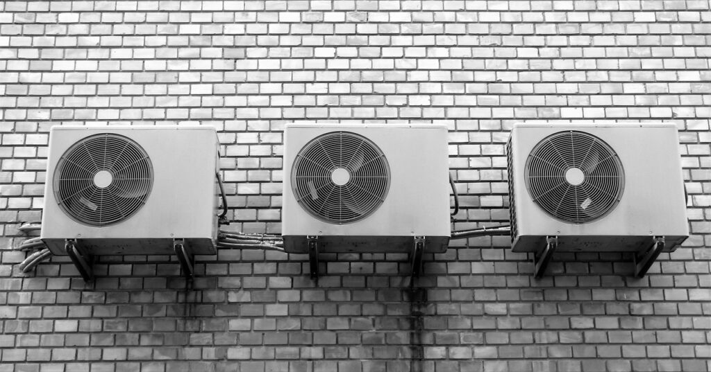 Three HVAC units on an exterior wall