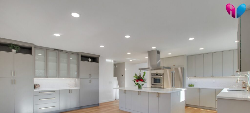 Recessed can lights above a large, open-concept kitchen