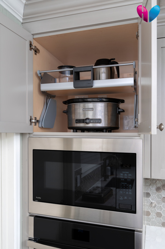 This best product is a cabinet-mounted pull down shelf, pictured here in the upright position above a microwave and an oven