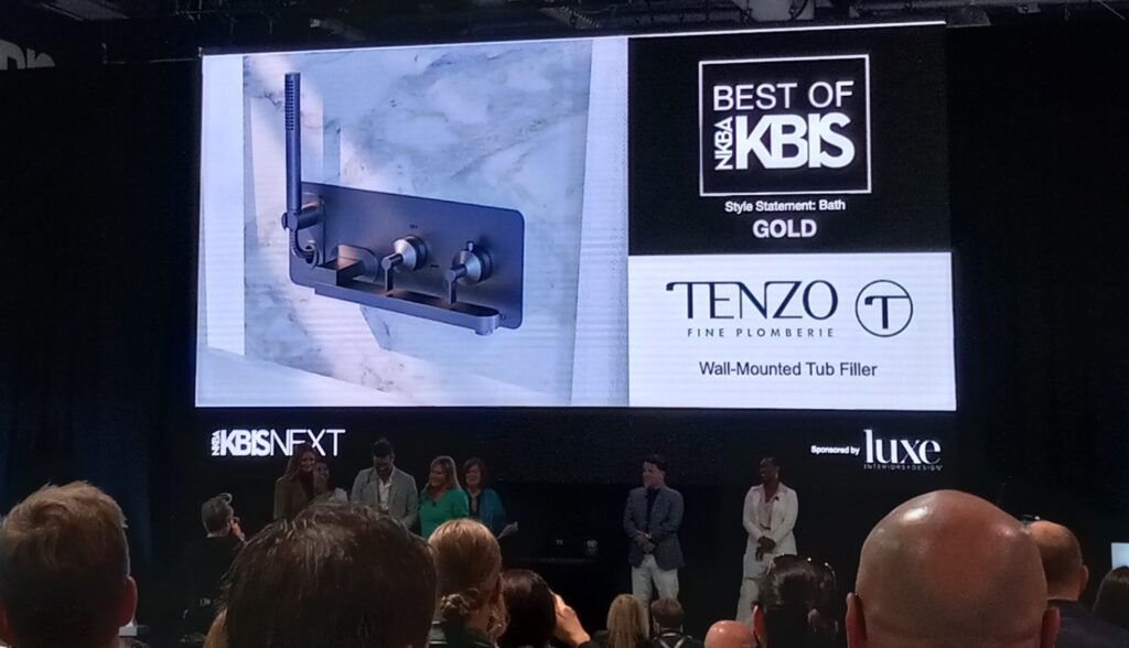 The Tenzo Wall-Mounted Tub Filler on screen behind the Best of KBIS stage